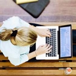 Student on Campus typing on laptop