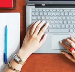 Student focused on studying with computer in library